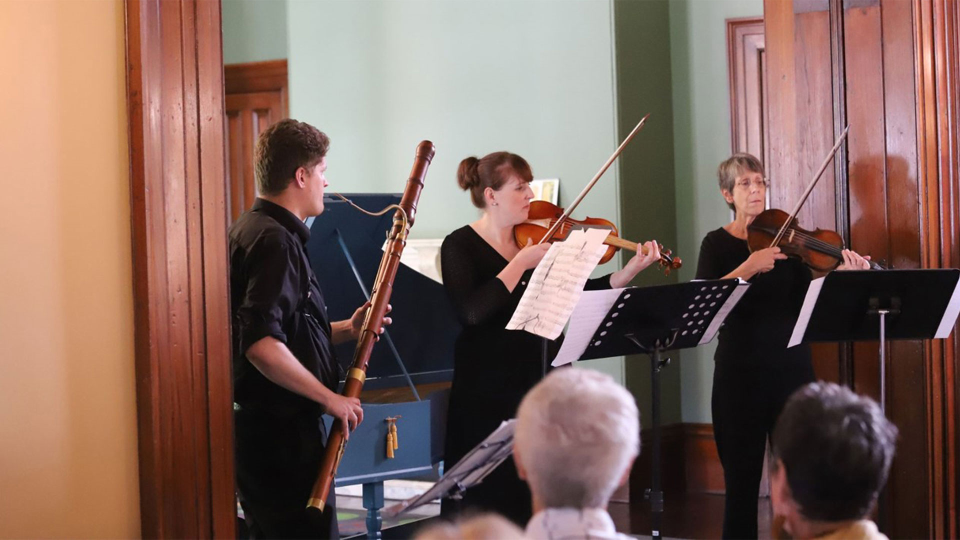 Three musicians playing inside Old Government House